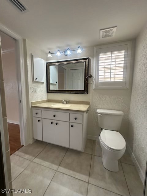 bathroom featuring tile patterned floors, toilet, and vanity