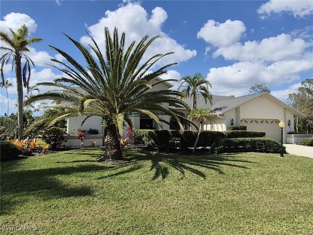 view of front of home with a garage and a front yard