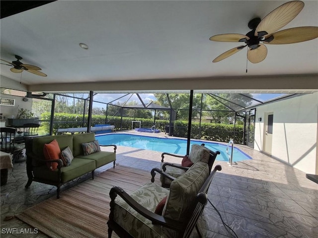 view of swimming pool with ceiling fan, an outdoor hangout area, a patio area, and a lanai