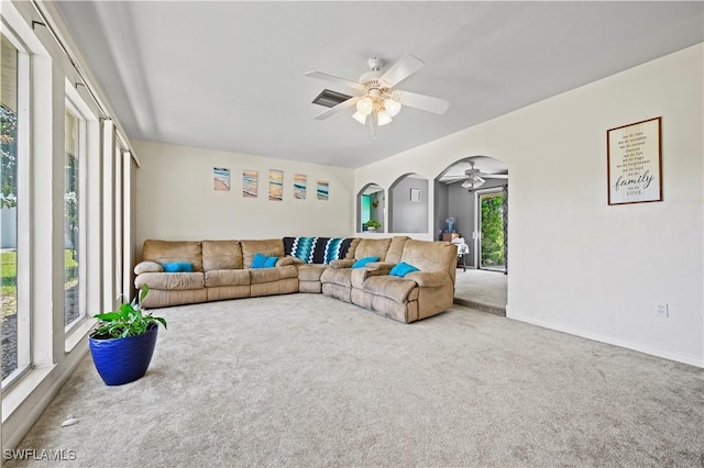 living room featuring carpet floors and ceiling fan