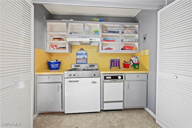 kitchen featuring white range oven and light colored carpet