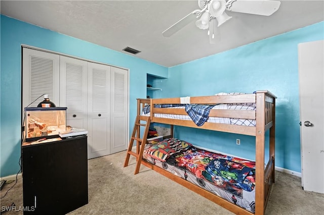 bedroom with carpet floors, ceiling fan, and a closet