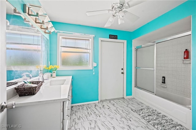 bathroom with ceiling fan, enclosed tub / shower combo, and vanity