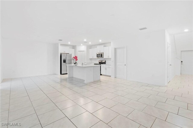12230 Dakota Ridge Pl, Lehigh Acres, FL 33974 - unfurnished living room with recessed lighting, a sink, and light tile patterned floors