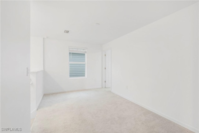 12230 Dakota Ridge Pl, Lehigh Acres, FL 33974 - empty room featuring light carpet and baseboards