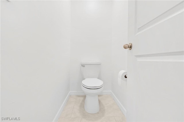 12230 Dakota Ridge Pl, Lehigh Acres, FL 33974 - bathroom featuring tile patterned flooring, toilet, and baseboards