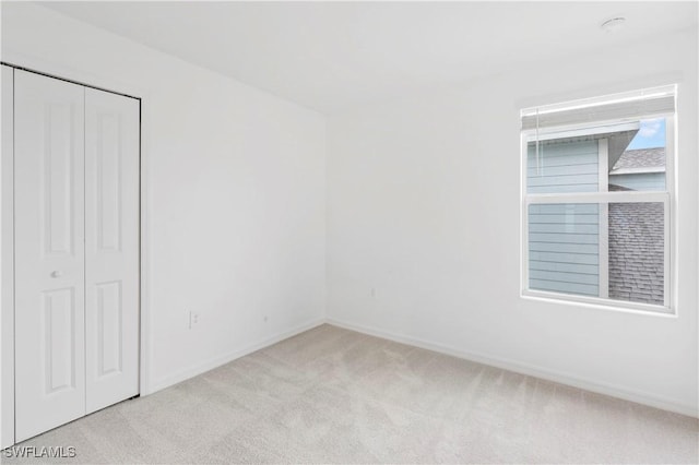 12230 Dakota Ridge Pl, Lehigh Acres, FL 33974 - unfurnished bedroom with carpet, baseboards, and a closet