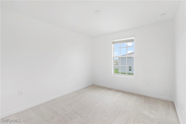 12230 Dakota Ridge Pl, Lehigh Acres, FL 33974 - carpeted spare room featuring baseboards