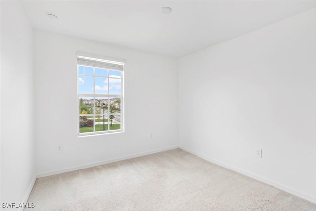 12230 Dakota Ridge Pl, Lehigh Acres, FL 33974 - spare room featuring light carpet and baseboards