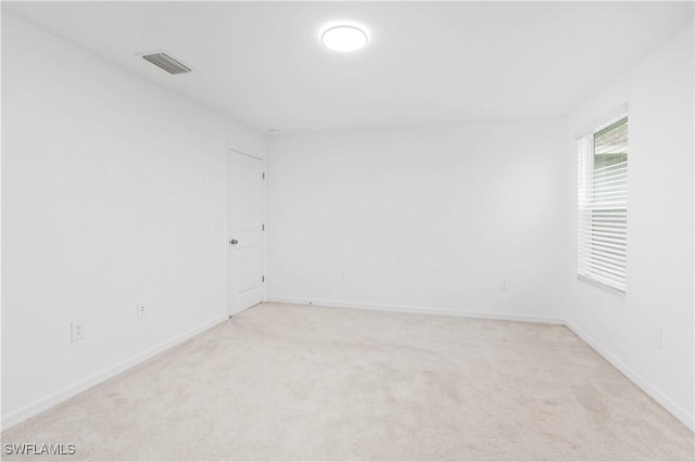 12230 Dakota Ridge Pl, Lehigh Acres, FL 33974 - spare room featuring light carpet and baseboards