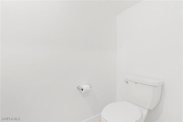 12230 Dakota Ridge Pl, Lehigh Acres, FL 33974 - bathroom featuring baseboards and toilet