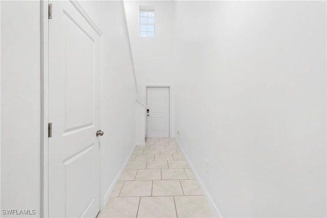 12230 Dakota Ridge Pl, Lehigh Acres, FL 33974 - corridor featuring light tile patterned floors and baseboards