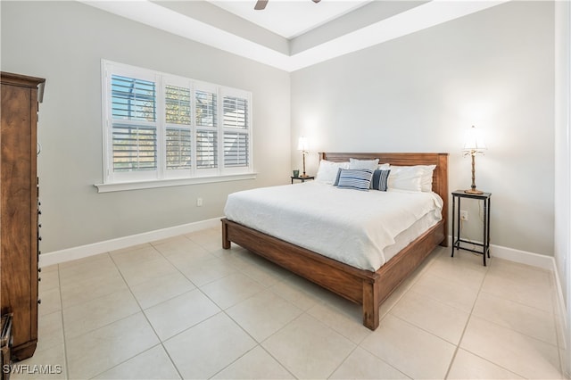 bedroom with ceiling fan, tile patterned flooring, and baseboards