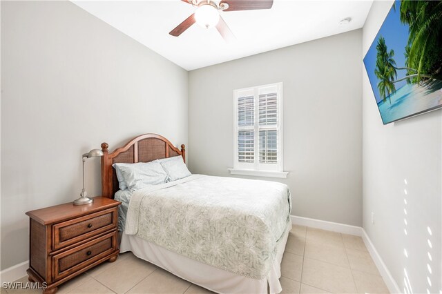 tiled bedroom featuring ceiling fan