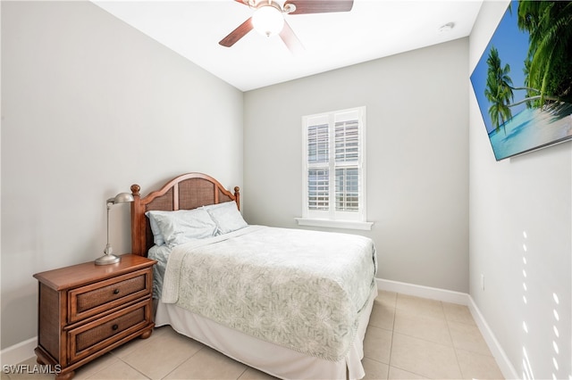 bedroom featuring a ceiling fan, light tile patterned flooring, and baseboards