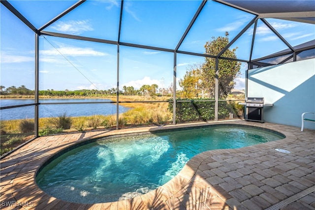 view of swimming pool with a water view, a grill, a lanai, and a patio area