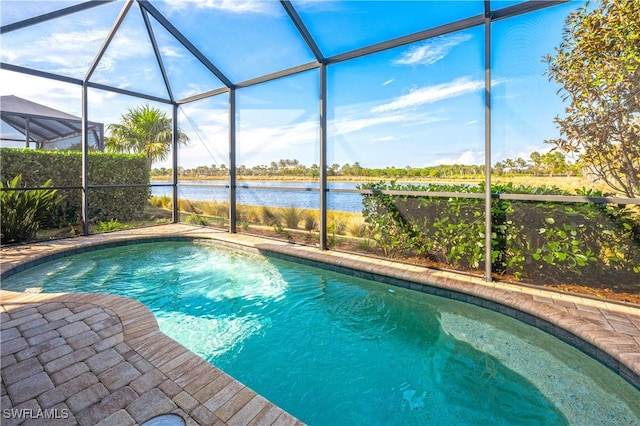 view of swimming pool featuring a water view and a lanai