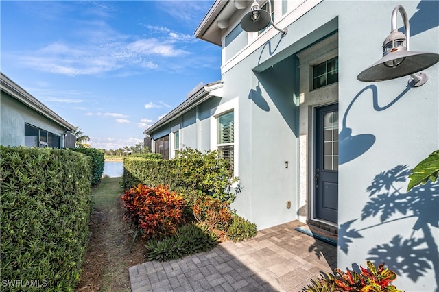 doorway to property featuring stucco siding