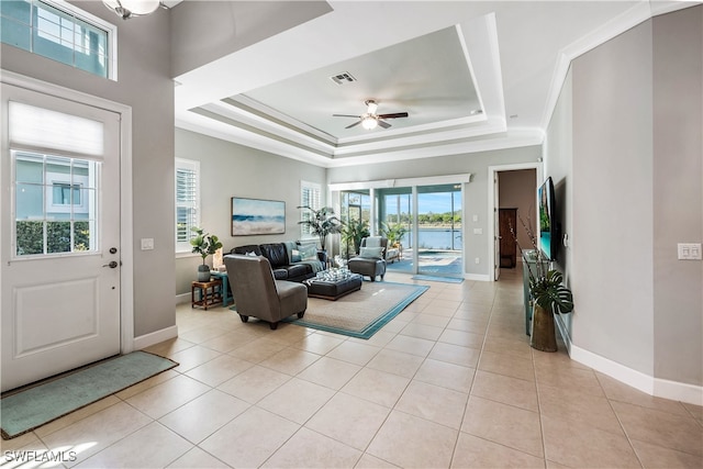 interior space featuring visible vents, a tray ceiling, and light tile patterned flooring