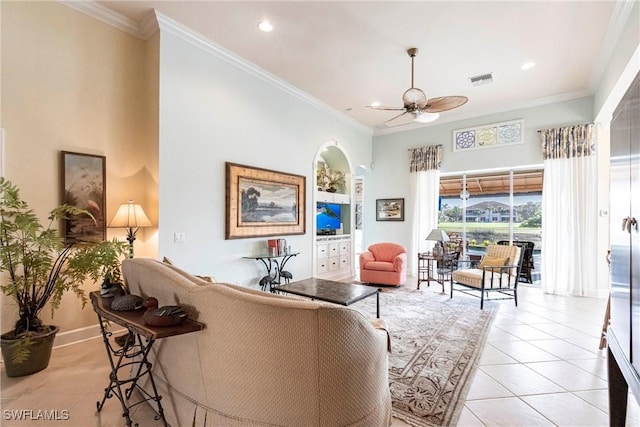 tiled living room with crown molding, ceiling fan, and a towering ceiling