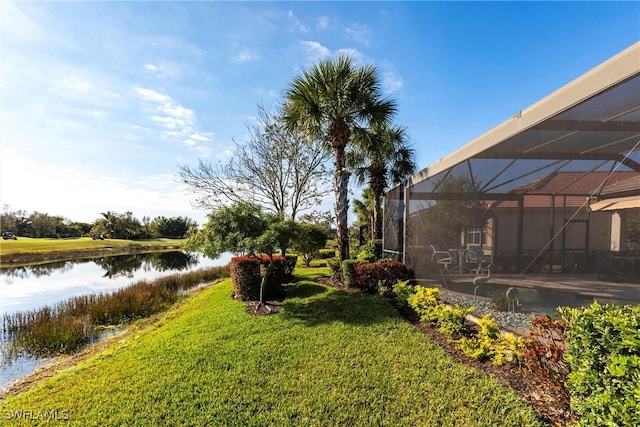 view of yard featuring a water view and glass enclosure