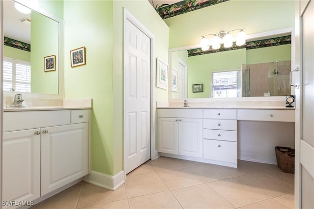 bathroom featuring tile patterned floors, a shower with shower door, and vanity