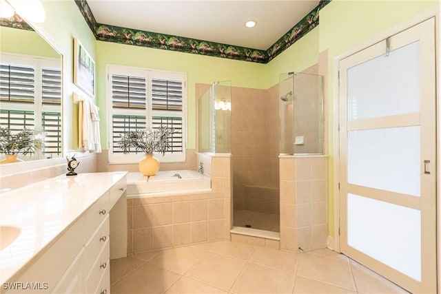 bathroom featuring vanity, shower with separate bathtub, and tile patterned flooring