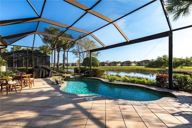 view of pool with a lanai, a water view, a grill, a patio area, and an in ground hot tub