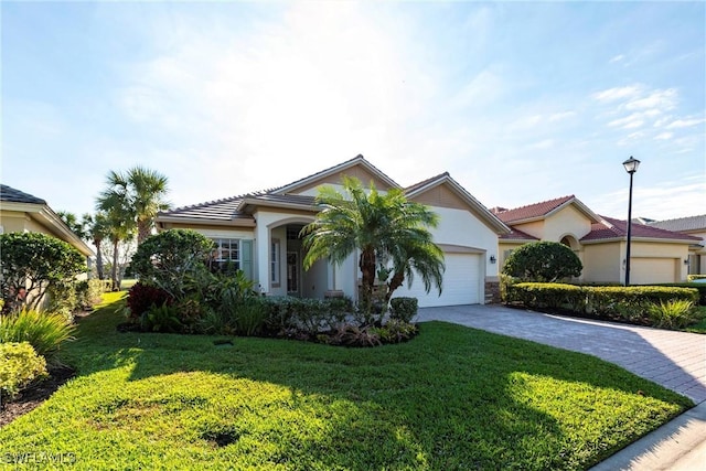 view of front of property with a garage and a front lawn