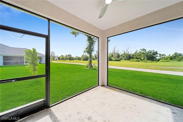 unfurnished sunroom featuring ceiling fan