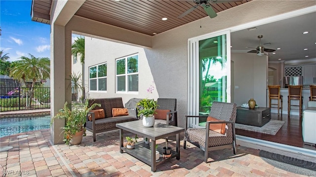 view of patio / terrace featuring an outdoor living space, ceiling fan, and fence