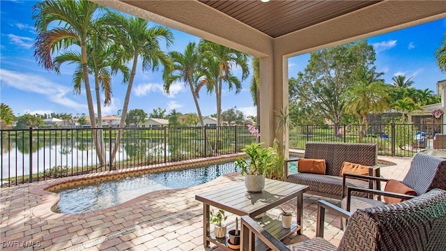 view of patio / terrace with a water view, a fenced backyard, and an outdoor hangout area