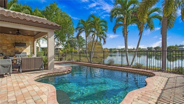view of swimming pool featuring a water view, area for grilling, ceiling fan, a fenced backyard, and a patio area