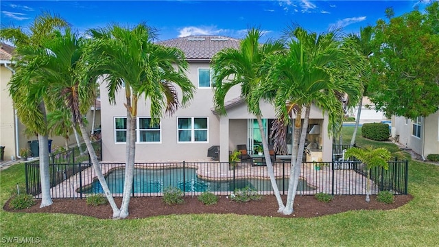 view of pool featuring a yard, a patio, a fenced in pool, and fence