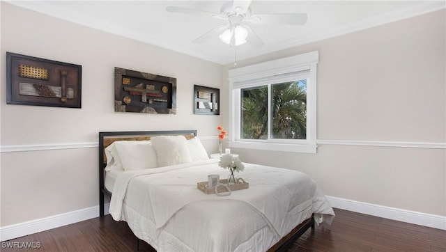 bedroom with ceiling fan, baseboards, and wood finished floors