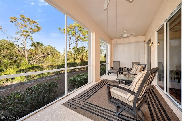 sunroom featuring ceiling fan