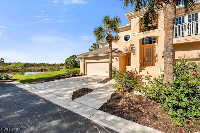 view of front of property featuring a water view and a garage