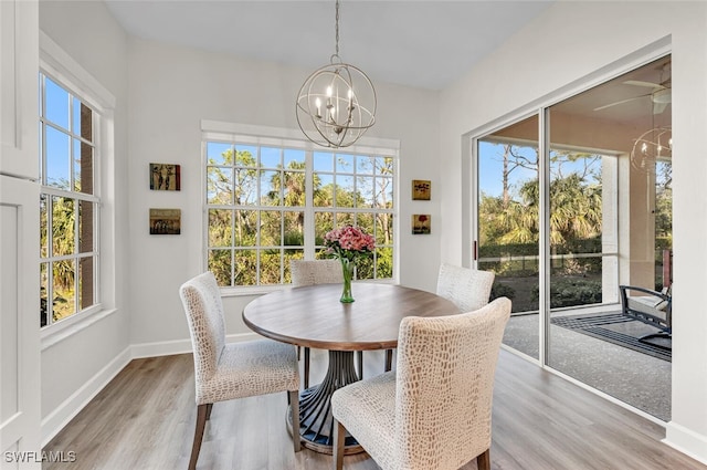 dining space with wood-type flooring and a notable chandelier