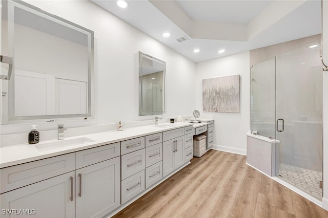 bathroom featuring vanity, an enclosed shower, and hardwood / wood-style floors