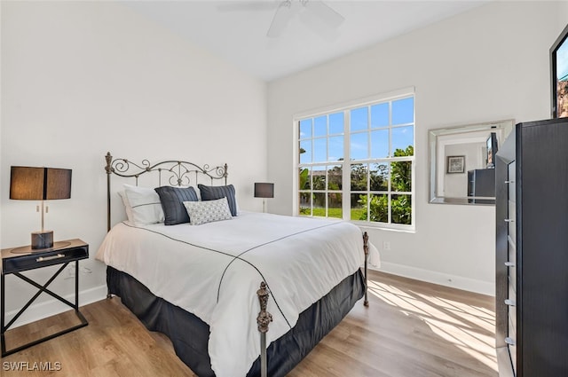 bedroom with ceiling fan and light hardwood / wood-style flooring