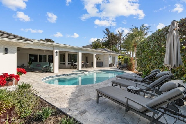 outdoor pool featuring a patio area and an outdoor living space