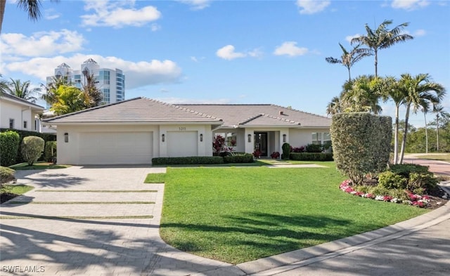 view of front of property with a garage and a front yard