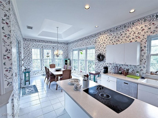 kitchen with pendant lighting, white cabinetry, sink, black electric stovetop, and white dishwasher