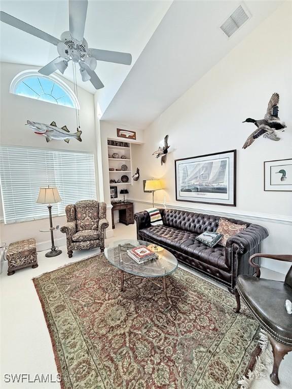 carpeted living room featuring lofted ceiling and ceiling fan