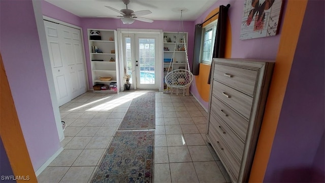 doorway to outside with light tile patterned flooring and ceiling fan