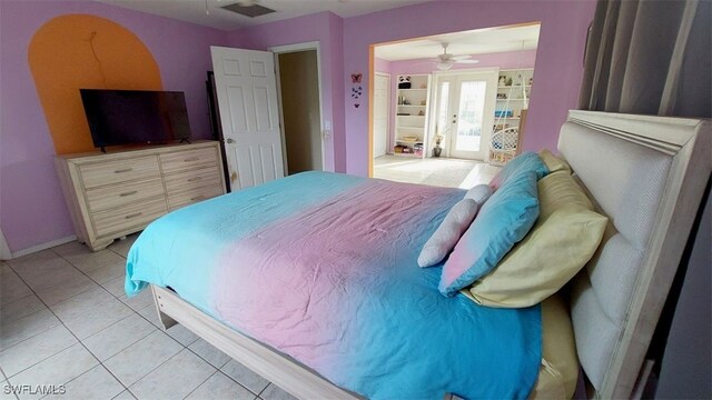 bedroom with light tile patterned floors and french doors