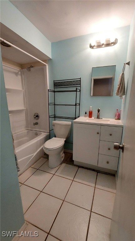 full bathroom with tile patterned floors, toilet, vanity, and washtub / shower combination