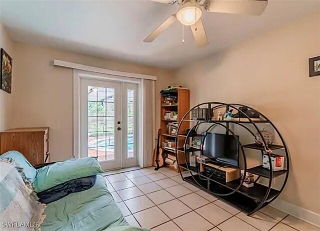 interior space with light tile patterned flooring, french doors, ceiling fan, and access to outside