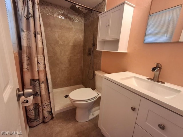 bathroom with toilet, vanity, and walk in shower