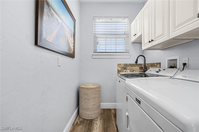 washroom featuring dark hardwood / wood-style flooring, independent washer and dryer, sink, and cabinets